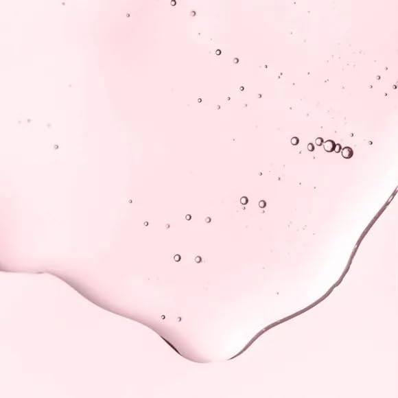 AVON Skin So Soft Soft & Sensual Bath Oil being poured into hand for post-shower nourishment.