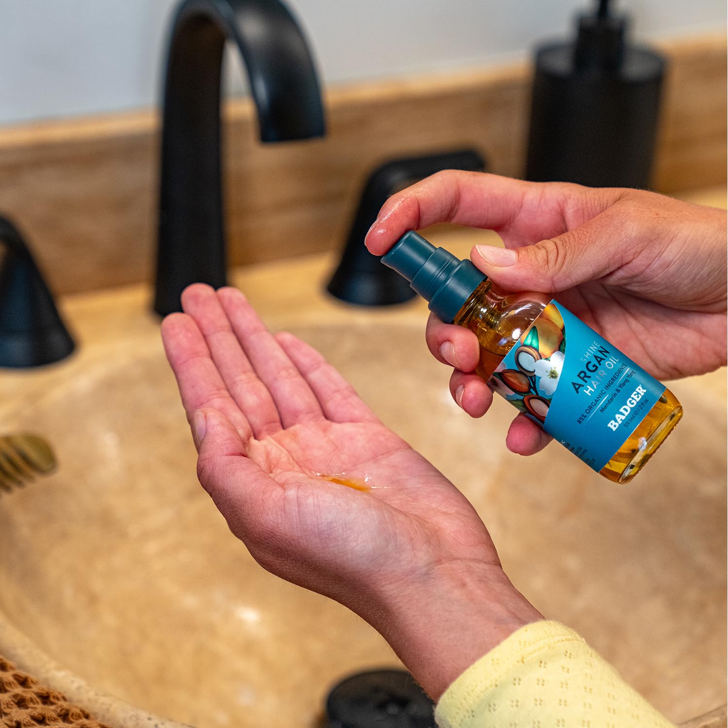 Badger Argan Hair Oil application on hair highlights quick absorption and natural shine.