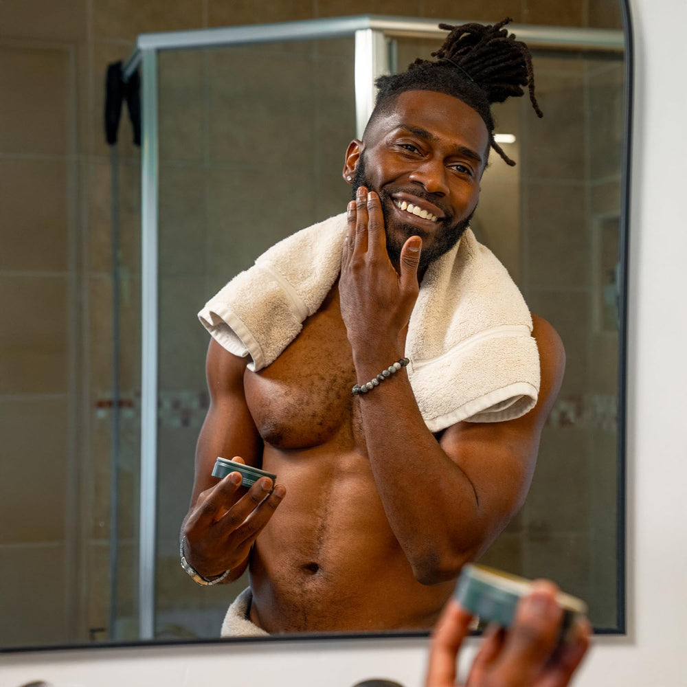 Badger Organic Beard Balm on a bathroom shelf for daily conditioning.