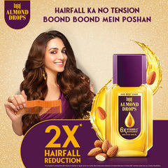 Close-up of Bajaj Almond Drops label emphasizing almond oil and Vitamin E for nourishing care