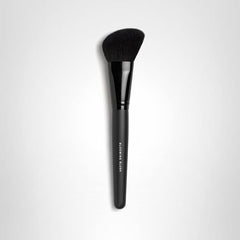bareMinerals Blooming brush angled tip aids bronzer and powder application on cheeks.