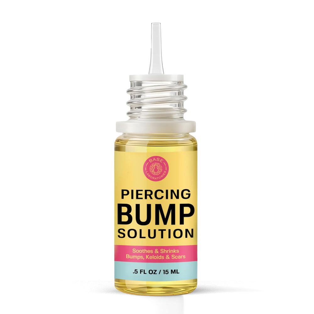 BASE LABORATORIES piercing-aftercare oil massaged onto bumps for soothing care