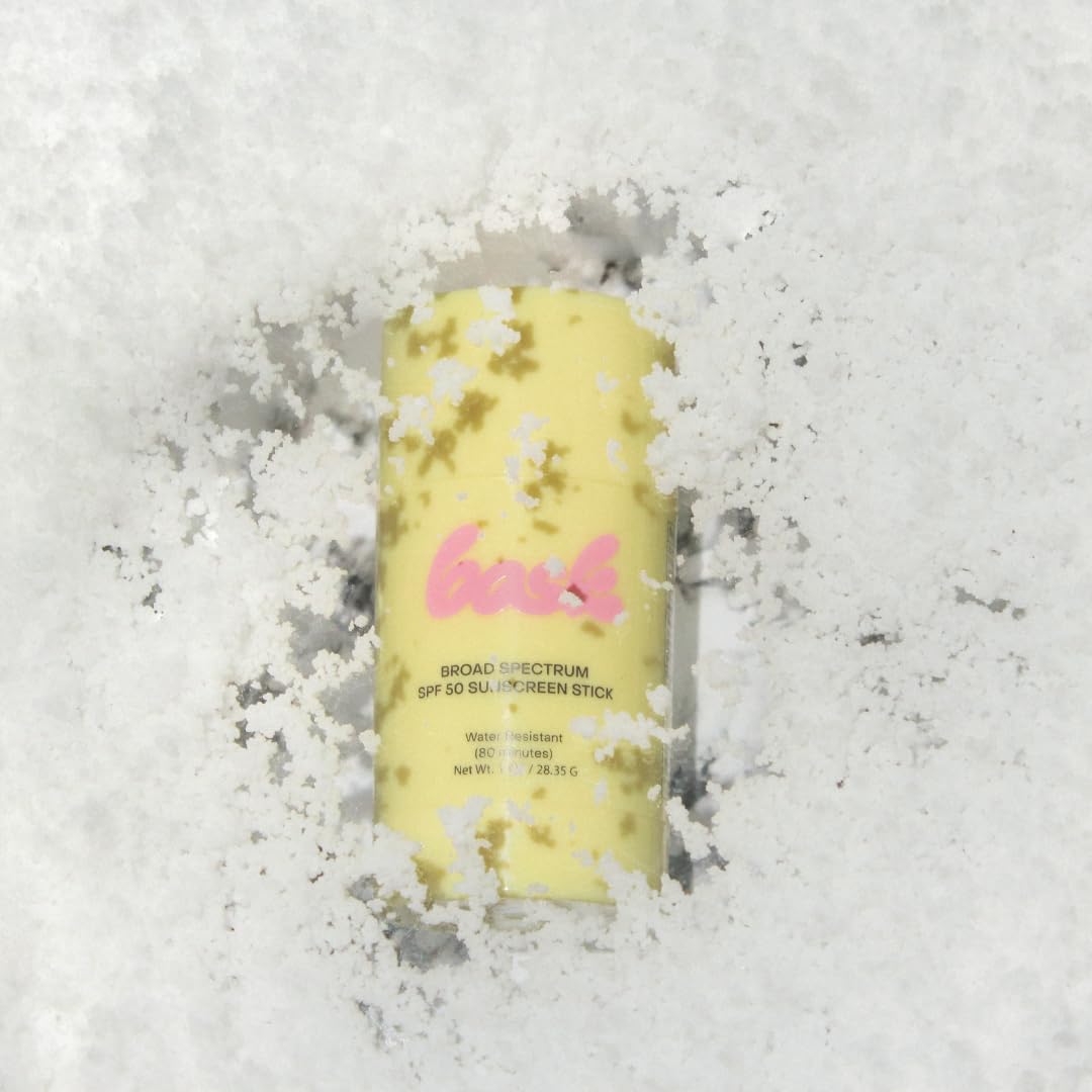 Bask SPF 50 sunscreen stick used on gloved hand to illustrate twist-up convenience.