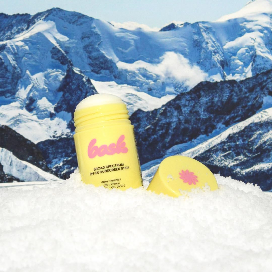 Bask SPF 50 sunscreen stick near lips for protective lip coverage outdoors.