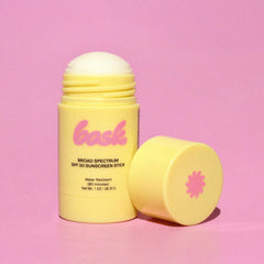 Bask SPF 50 sunscreen stick tucked in a jacket pocket for travel-friendly sun care.