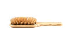 Bass The Green Brush closeup reveals wood bristles for reduced static and a soothing scalp massage.