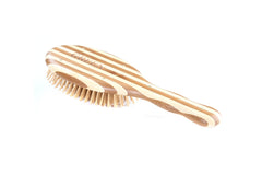 Bass Green Brush detangling a knot during a routine hair session.