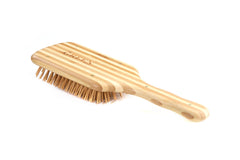 Bass The Green Brush large paddle in use supports styling and smoother blow-drying with bamboo bristles.