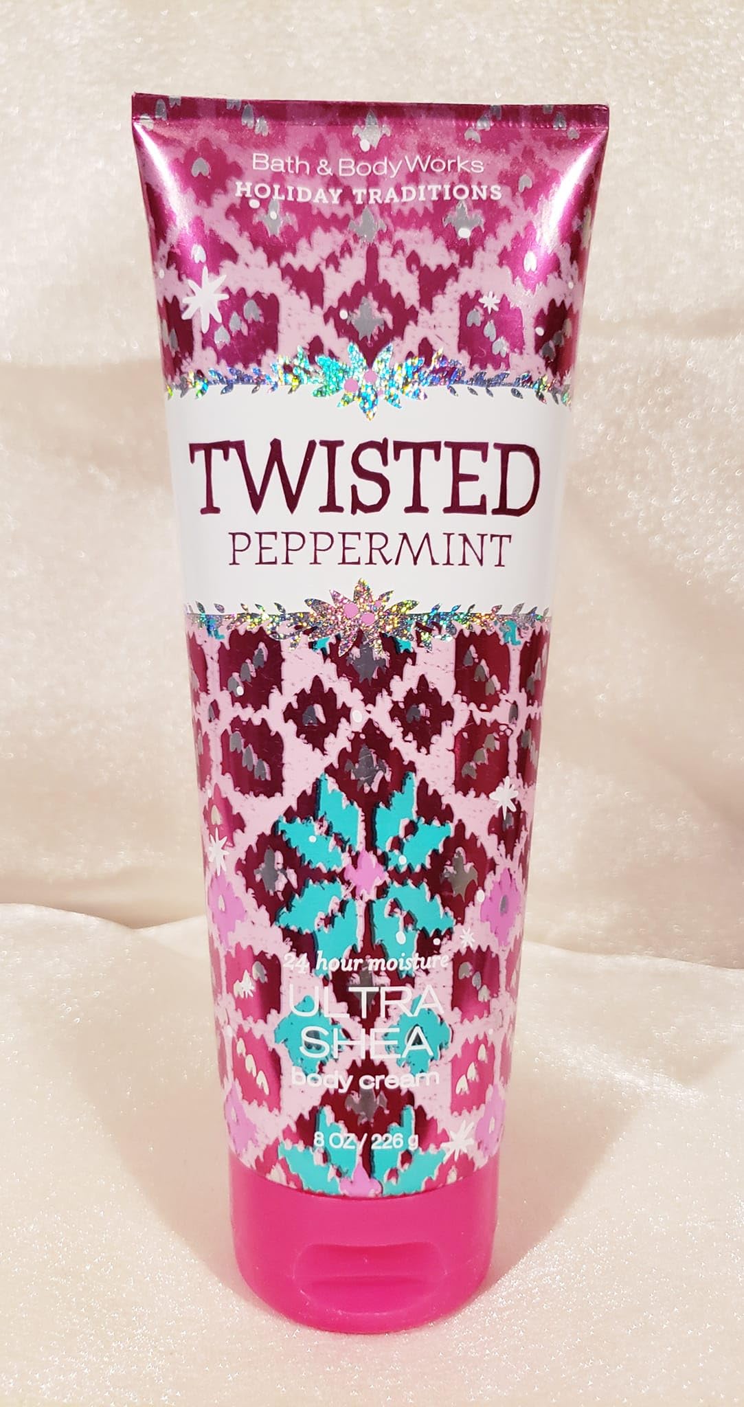 Bath & Body Works Twisted Peppermint cream tube being squeezed for application.