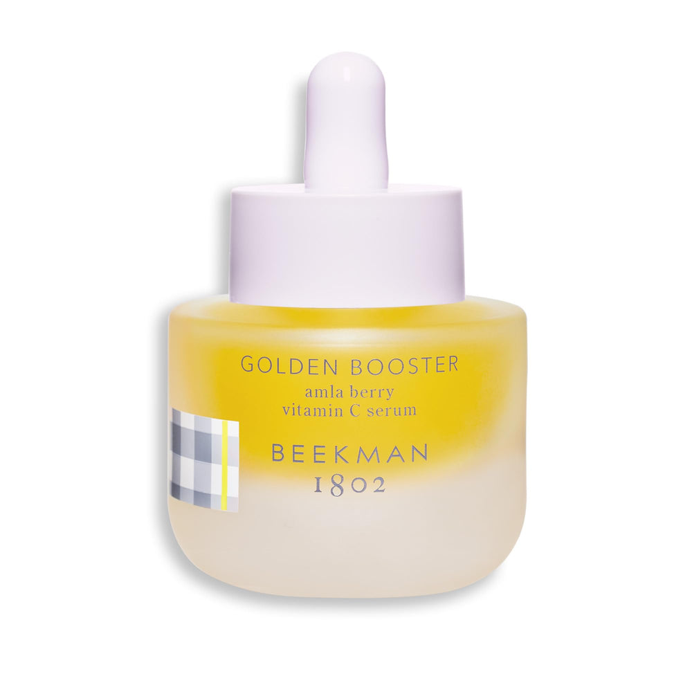 Beekman 1802 Golden Booster serum bottle highlights amla vitamin C for brightening skin tone.