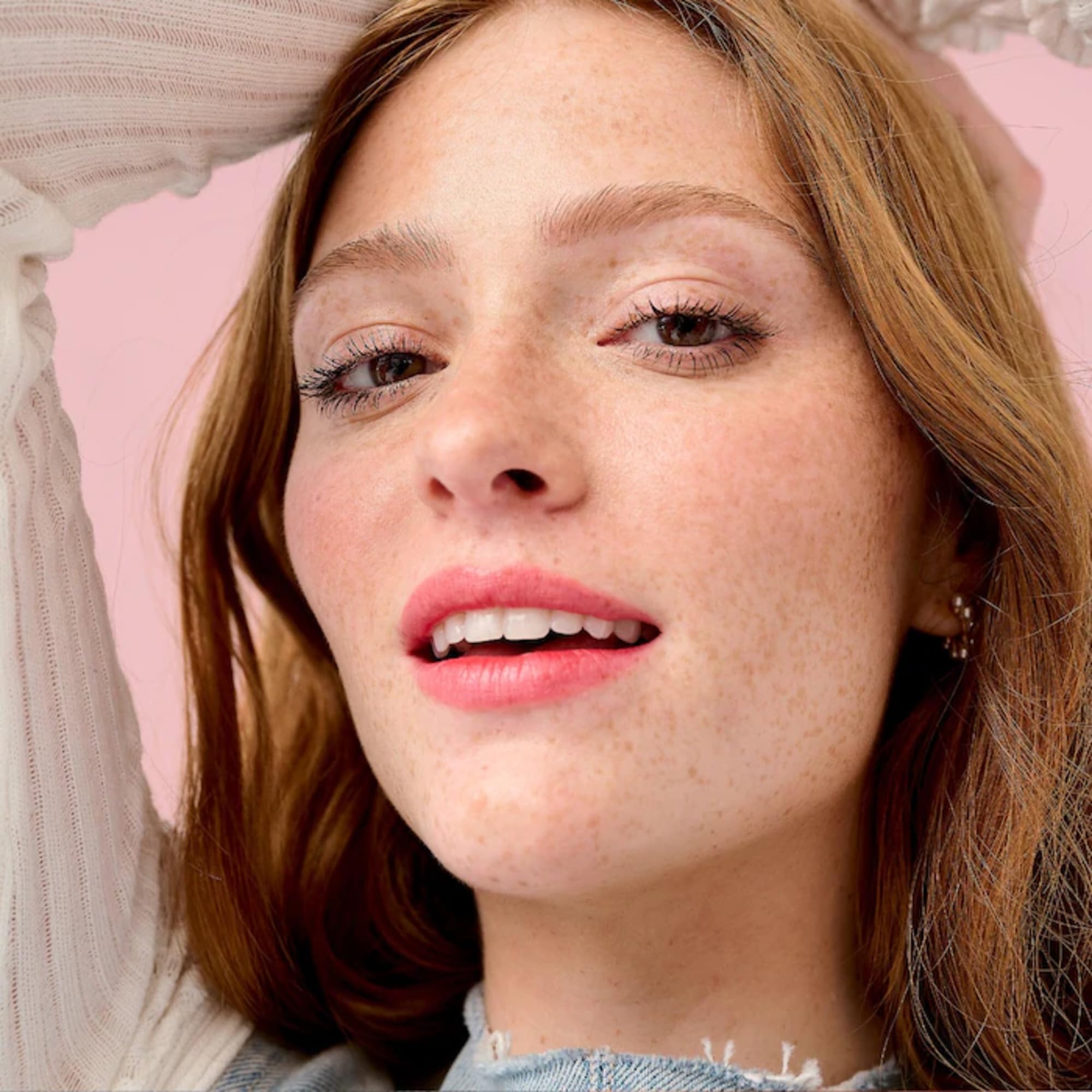 Benefit on a vanity with makeup tools suggesting everyday wearable volume