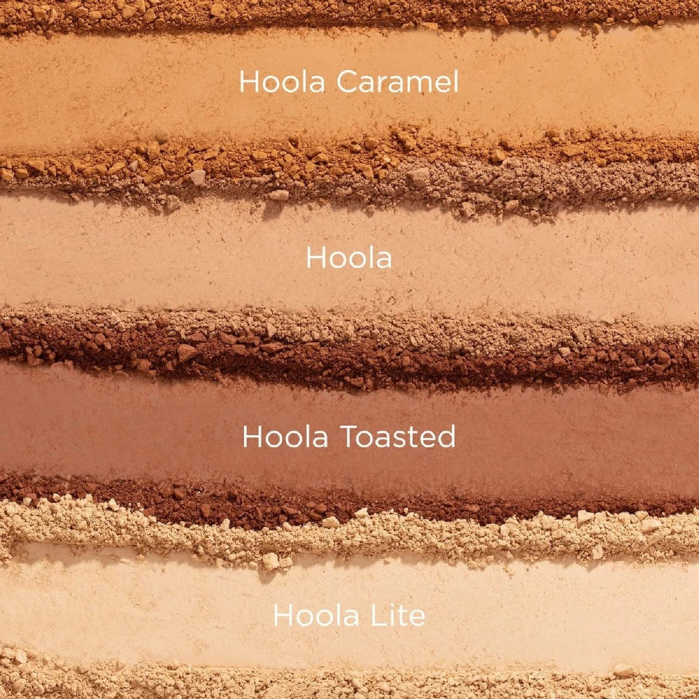 Benefit Hoola Caramel compact beside makeup brush showing compact size and everyday use