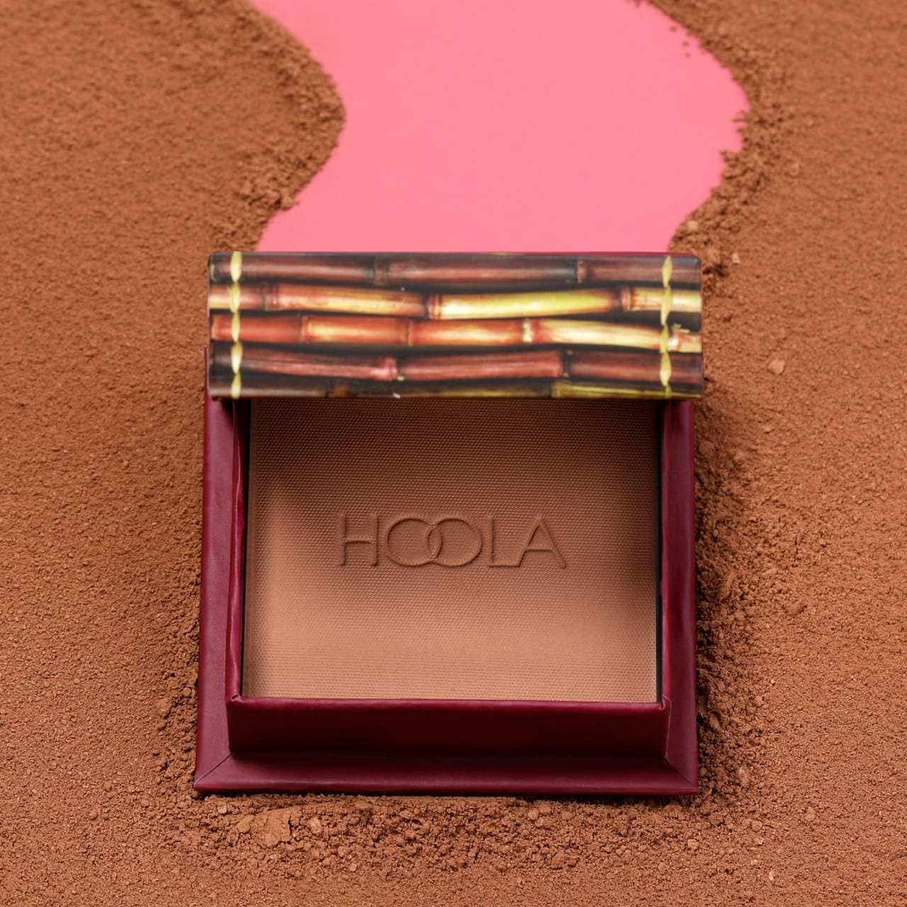 Benefit Hoola nestled in a beauty bag with other products highlighting convenience benefit