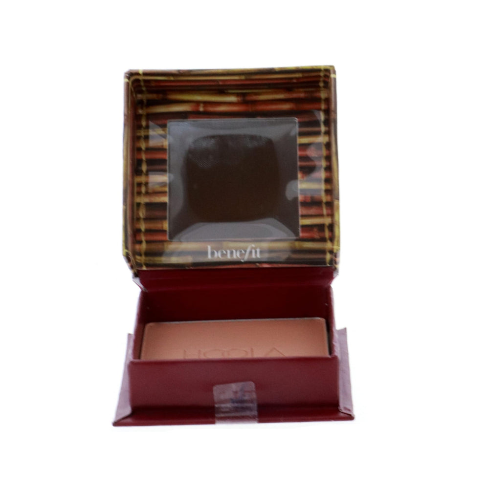 Benefit Hoola next to makeup brush showing compact size and portable convenience