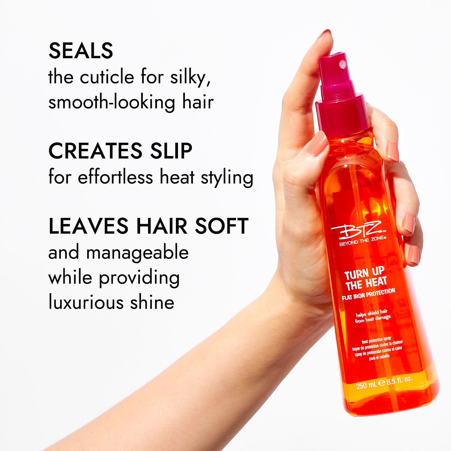 Beyond The Zone Turn Up The Heat Protection Spray misting on hair for even coverage and styling slip.