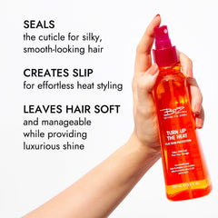 Beyond The Zone Turn Up The Heat Protection Spray misting on hair for even coverage and styling slip.
