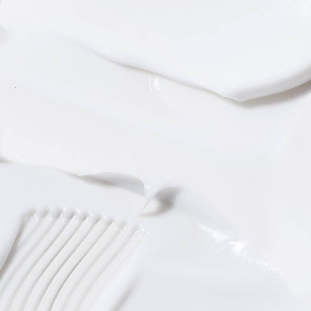 BIOSSANCE Squalane + Omega Repair Hand Cream being applied to hands for day-and-night hydration.