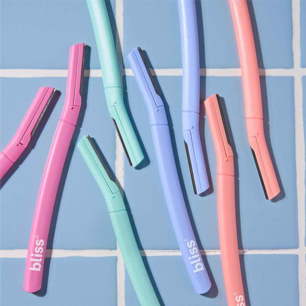 Bliss dermaplaning tool in use demonstrating easy grip during facial exfoliation.
