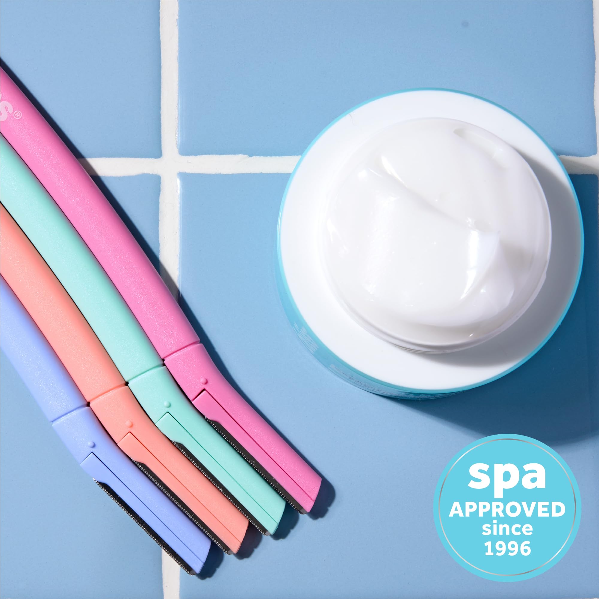 Bliss tool removing peach fuzz from cheek for a smoother base.