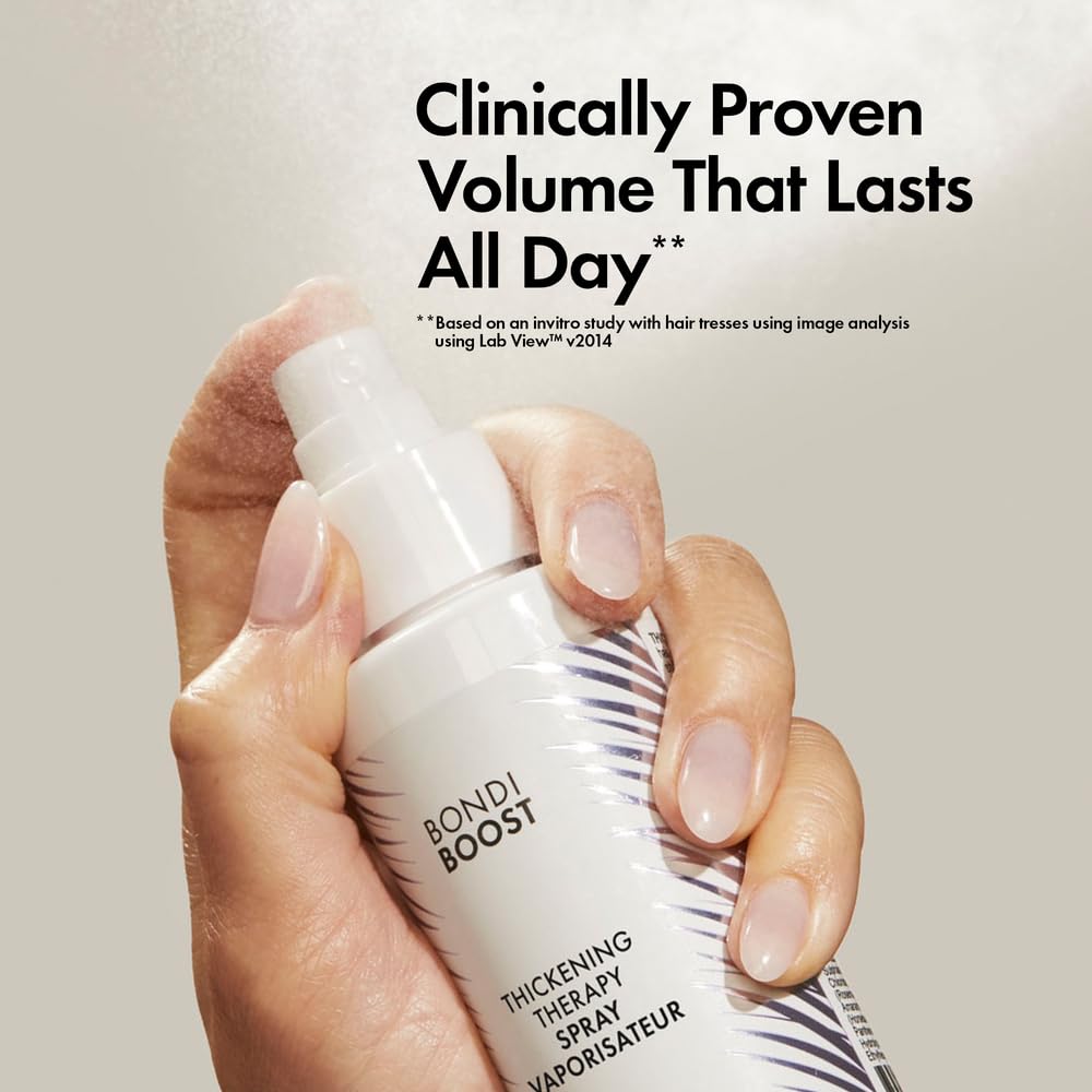 Close-up of the spray nozzle dispensing a lightweight volumizing formula.