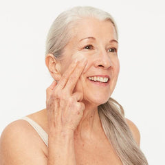 Boomsilk fingertip application image showing easy, one-cream routine for face and body