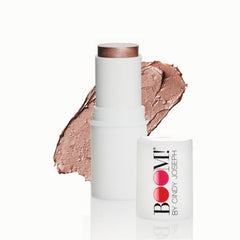 Boomstick Glimmer highlighter stick cap closeup showing portable design for on-the-go radiance.