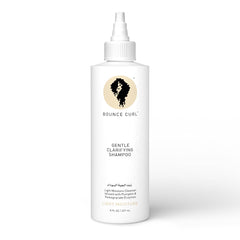 Bounce Curl Enzyme Gentle Clarifying Shampoo bottle pour shows balanced moisture.
