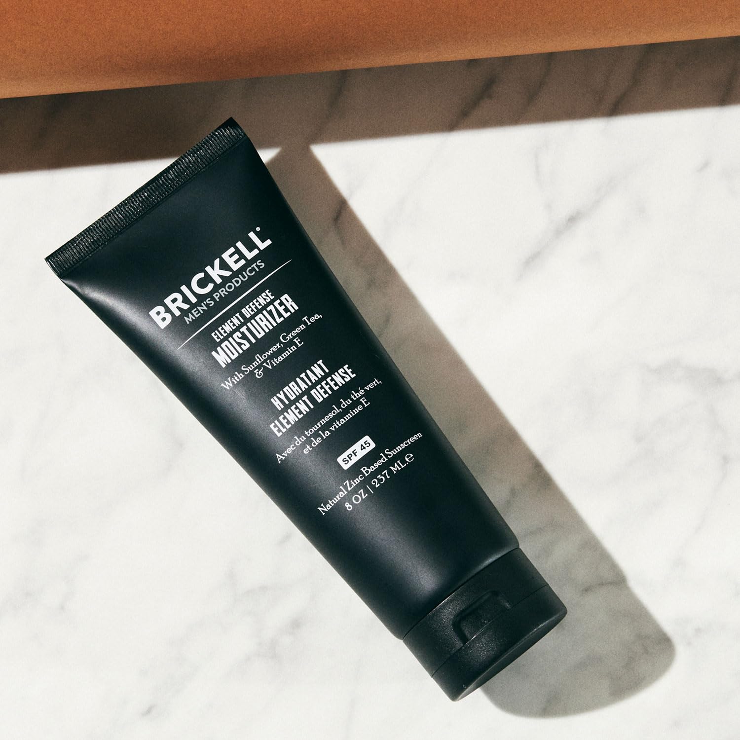 Brickell Men's Element Defense SPF45 application on face demonstrates quick rub-in.