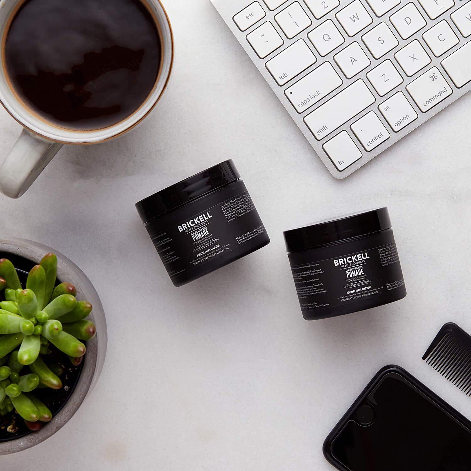 Brickell Men's pomade being applied for a smooth slick-back with strong hold.
