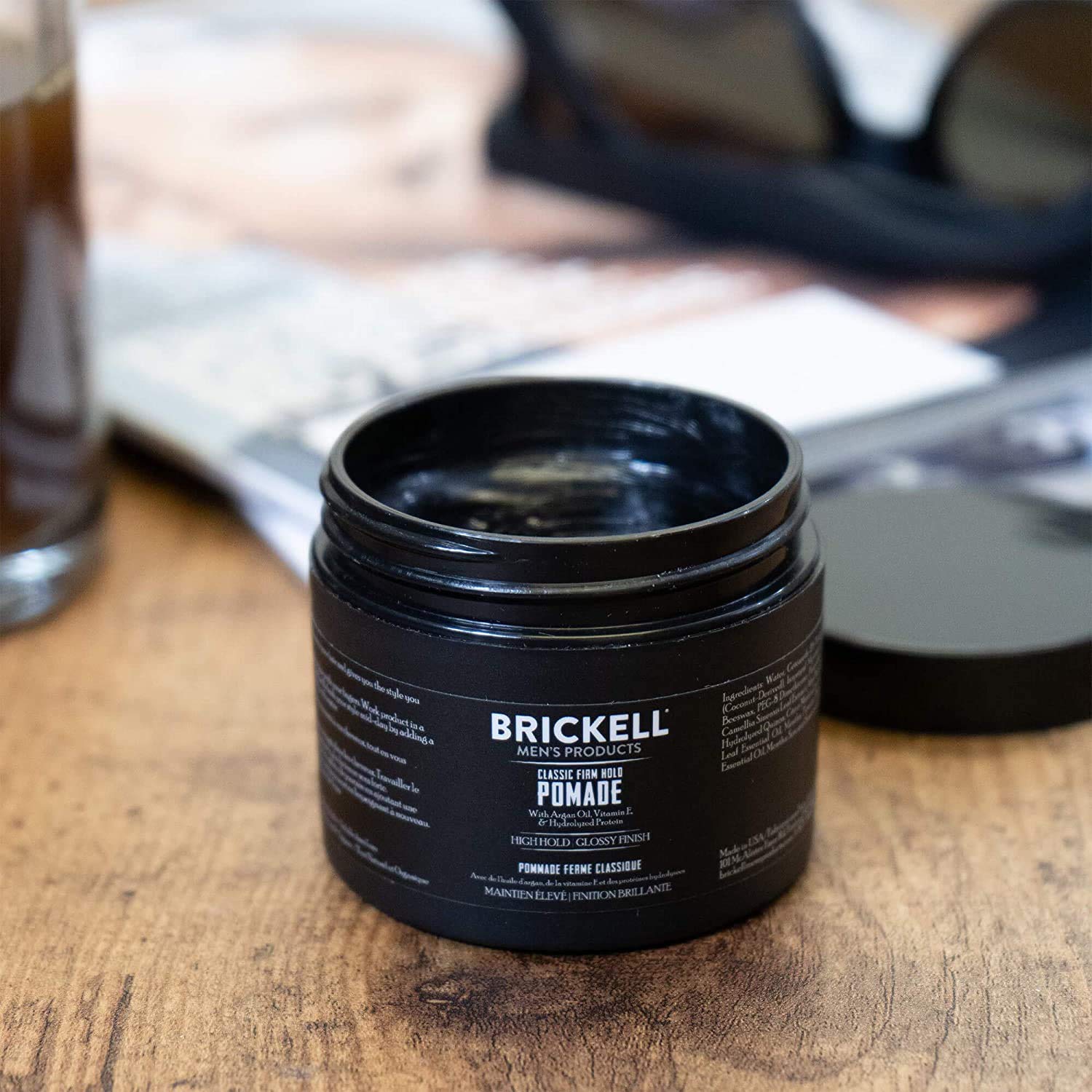 Brickell Men's pomade glossy finish enhances sleek hairstyles with a polished look.