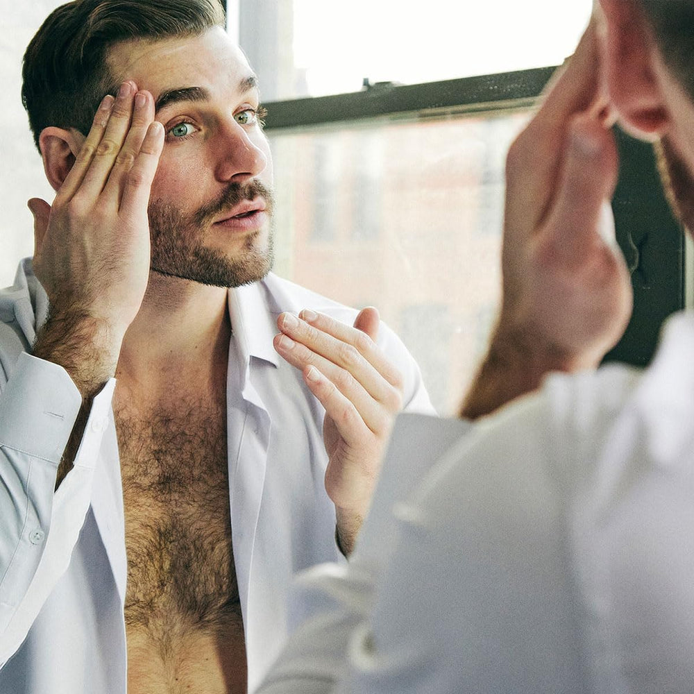 Brickell Men's night serum application shows smooth glide for nighttime skin care.