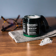 Brickell Men's Purifying Charcoal Face Mask application showing smooth spread for deep cleansing.