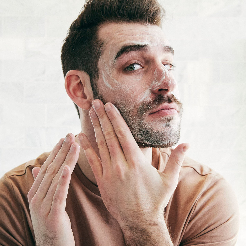 Brickell Men's Purifying Charcoal Face Wash foaming application demonstrates deep-clean without drying