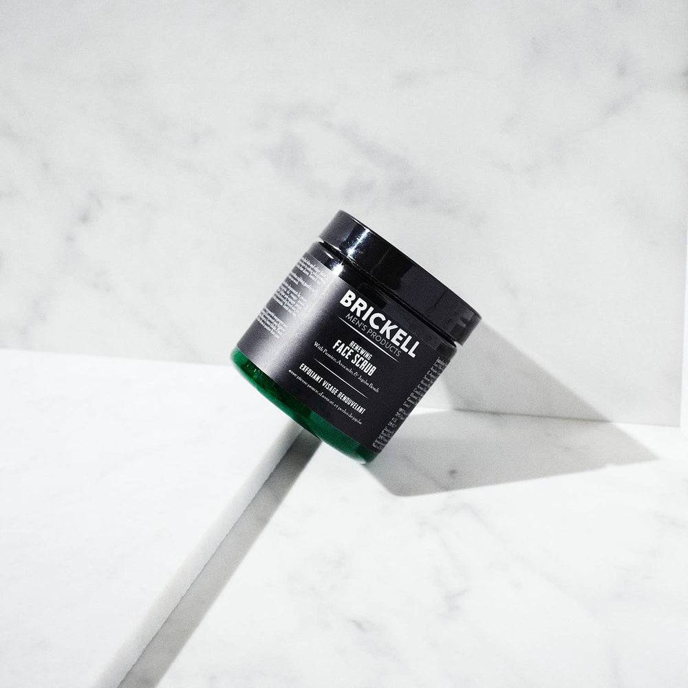 Brickell Men's Renewing Face Scrub with jojoba beads demonstrates gentle exfoliation for smoother skin.