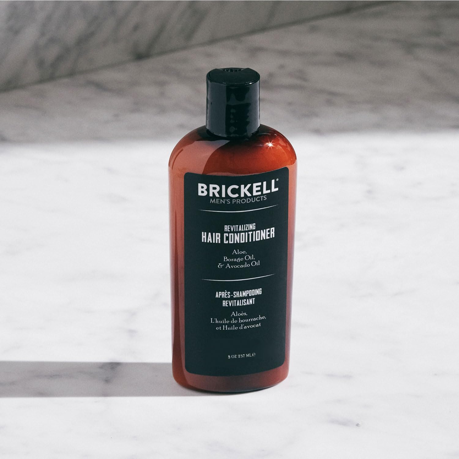 Brickell Men's Revitalizing Hair Conditioner label highlights organic ingredients for color-treated hair.