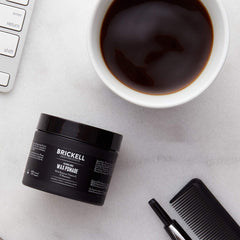 Brickell Men's wax pomade on hands illustrates easy application and conditioning.