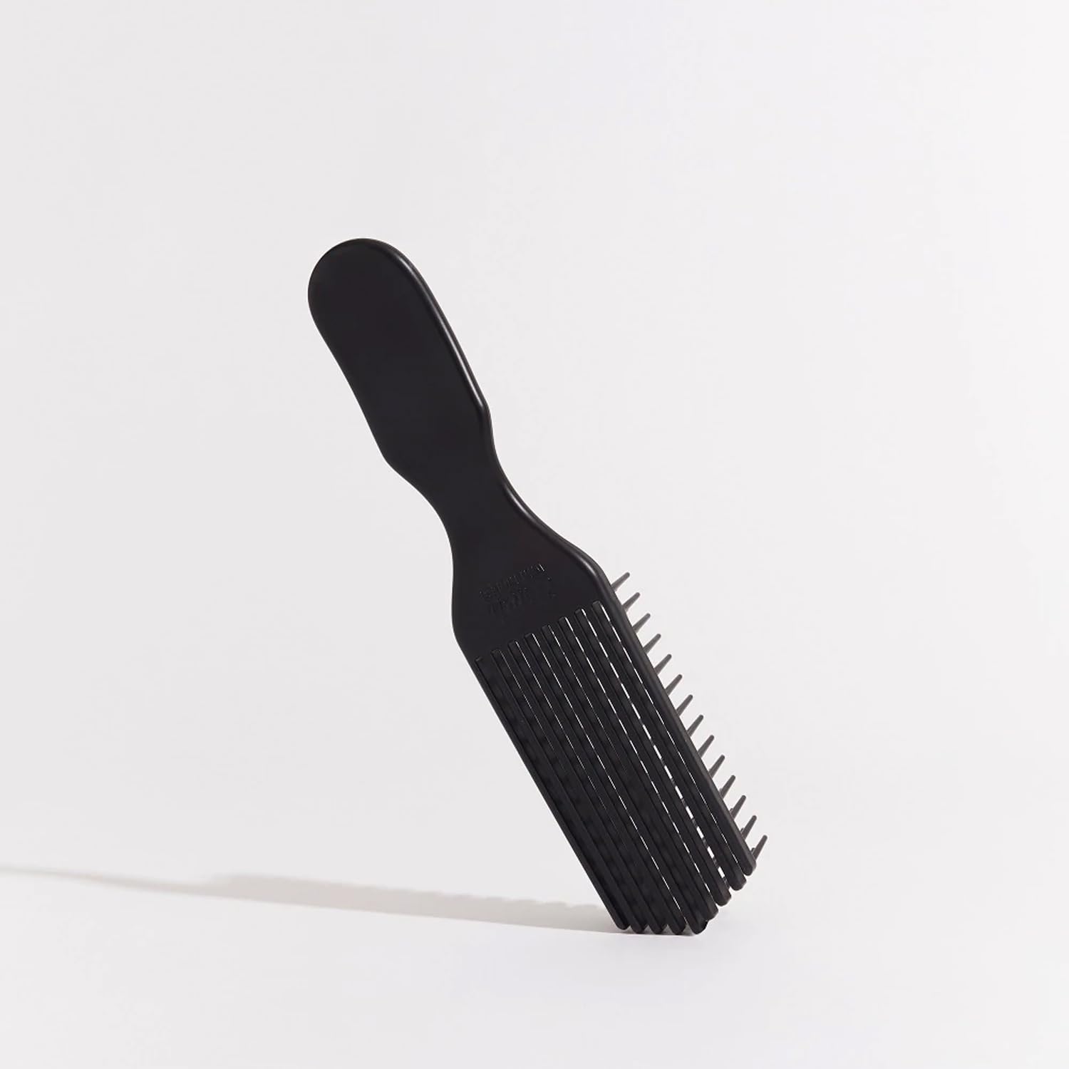 Brush With The Best Detangler Brush in action on curly hair for smoother coils.