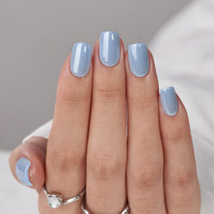 BTArtbox blue glossy nails shown close-up with a seamless cuticle line for natural-looking results.