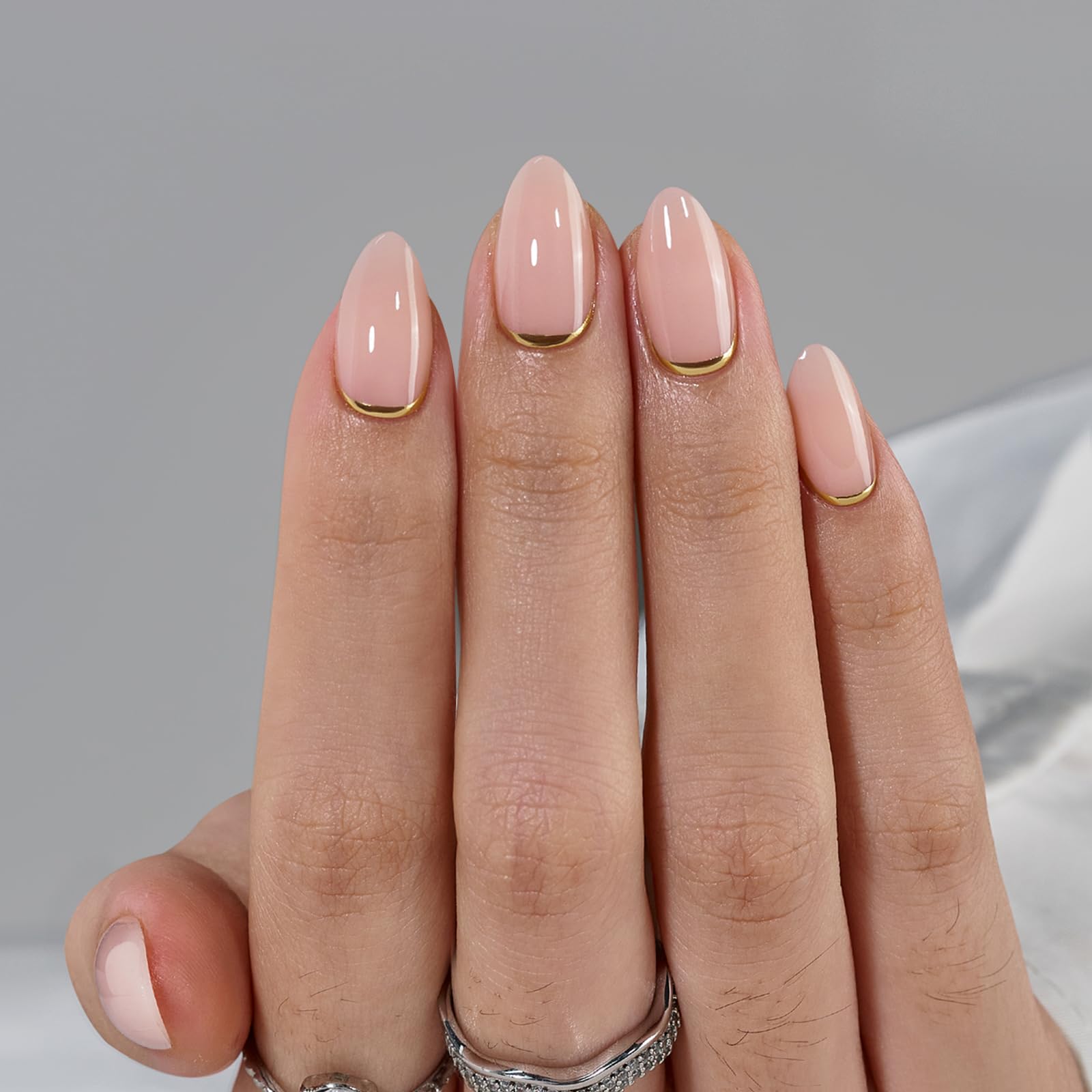BTArtbox press-on nails almond short gold foil closeup shows sheer nude base with shimmer.