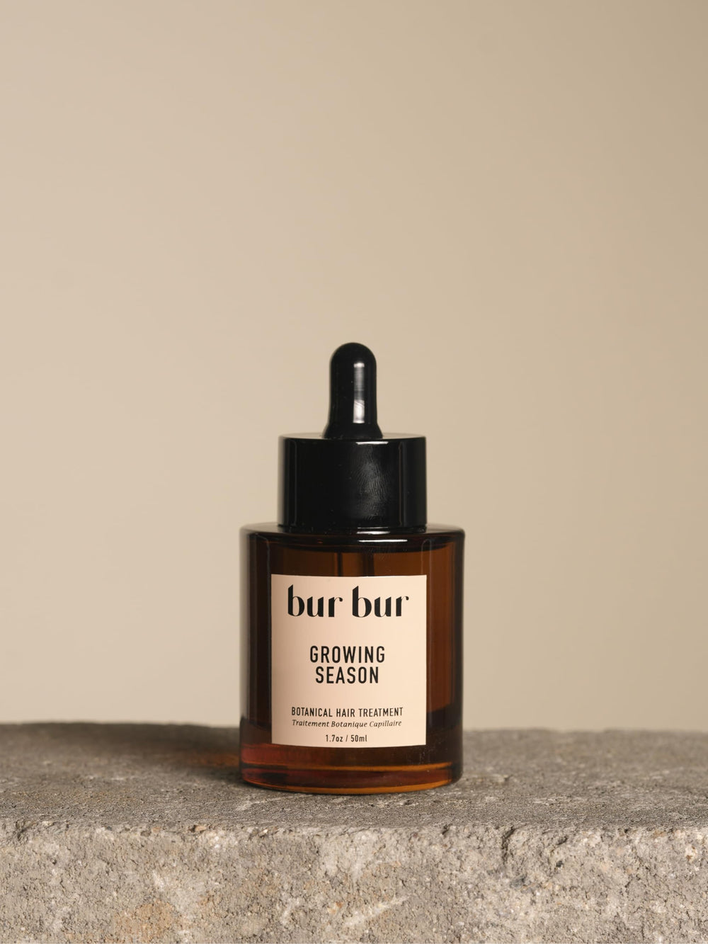 Bur Bur Growing Season Oil bottle closeup showcases nourishing formula for healthier follicles.