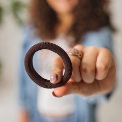 Burlybands non-damage hair tie being removed gently without tugging.