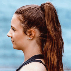 Burlybands seamless ponytail scrunchie in brown demonstrates crease-free removal.