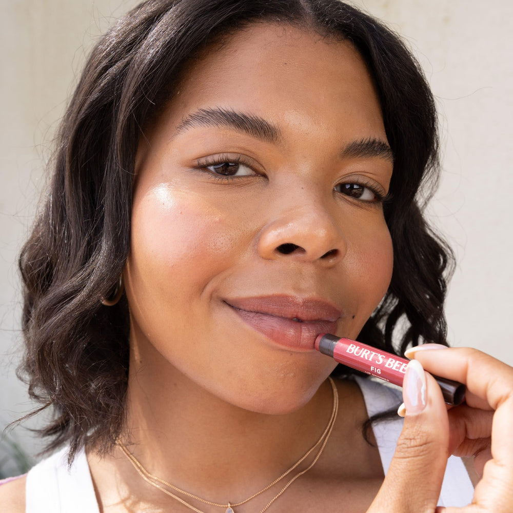 Burt's Bees Lip Shimmer Plum creamy texture with shea and cocoa moisture.