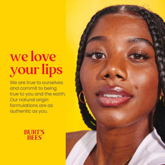 Burt's Bees tube in hand to show compact size and travel convenience
