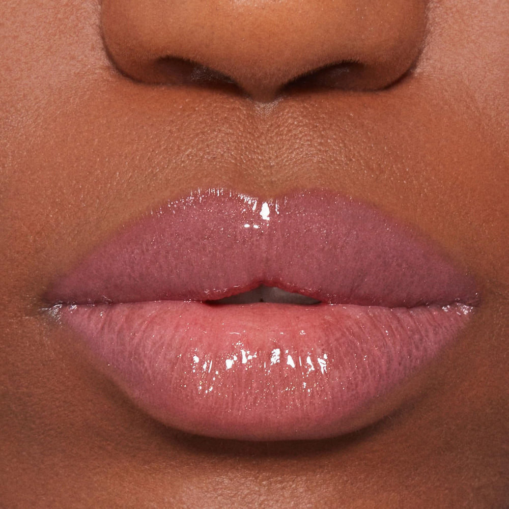 BUXOM Dolly lip polish on lips delivering tingling plump in a non-sticky gloss