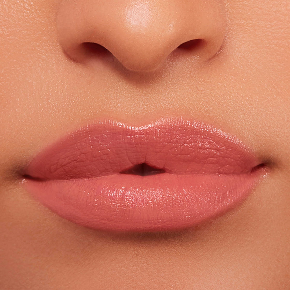 Buxom Power-Full Plumping Lip Balm Inner Glow swatch shows sheer satin finish.