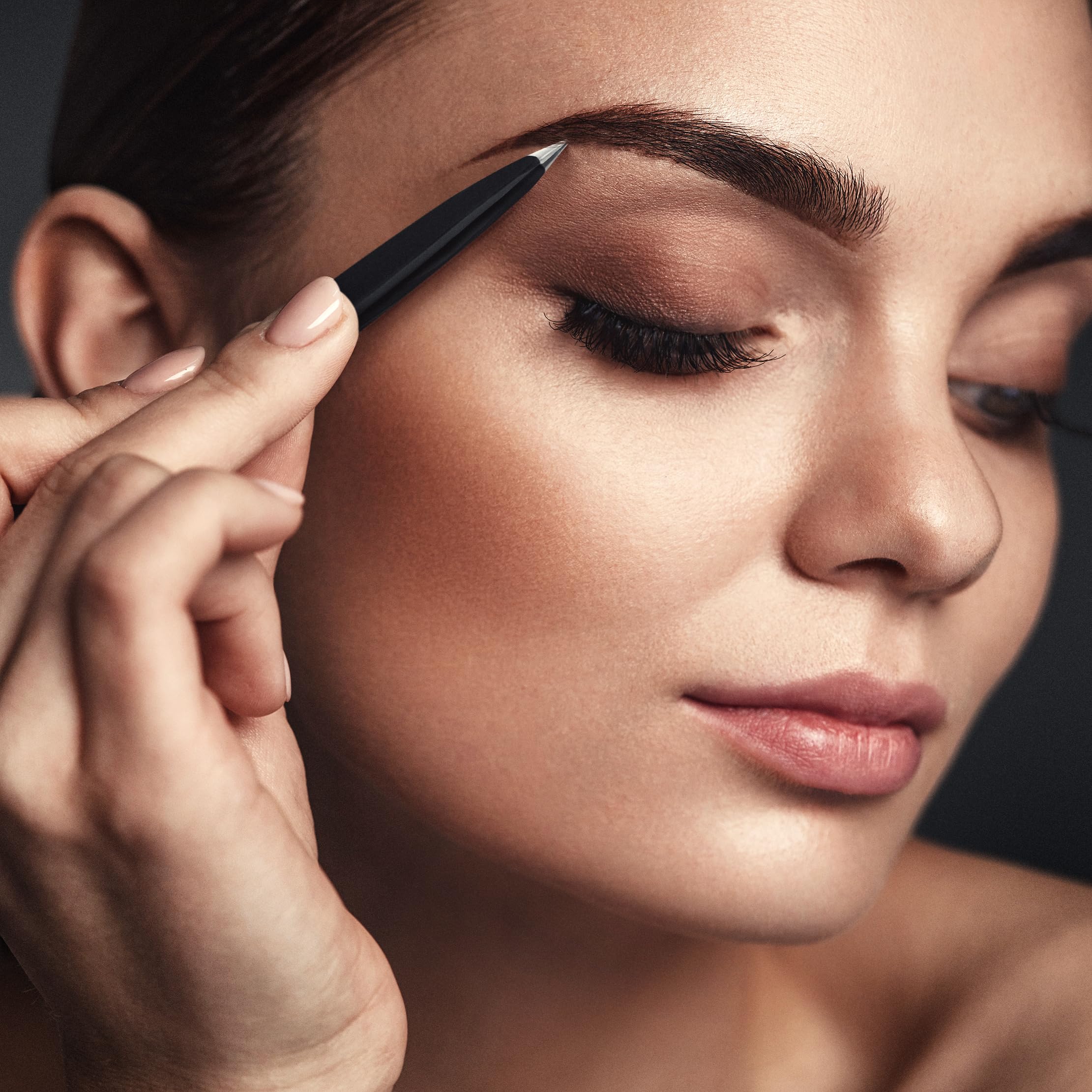 By MILLY pointed tweezers black finish shown for sleek daily use