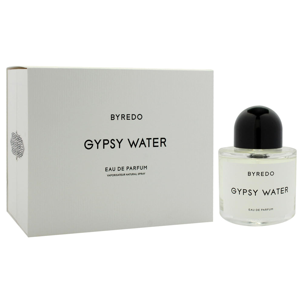 Byredo Gypsy Water bottle on wooden table conveys timeless, versatile scent presence.