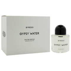 Byredo Gypsy Water bottle on wooden table conveys timeless, versatile scent presence.