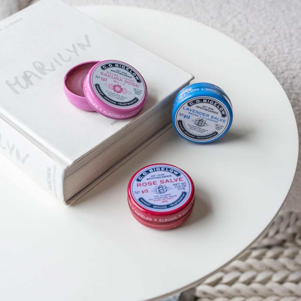 C.O. Bigelow compact salve tins shown as travel-friendly skin care.